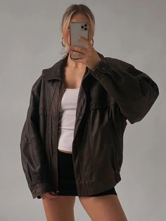 Embrace the spirit of the '90s with this oversized vintage dark brown genuine leather bomber jacket. Made from luxurious leather, this piece boasts a soft, supple feel that elevates any outfit. The oversized silhouette offers a relaxed, laid-back vibe, making it perfect for layering over your favorite tees or sweaters. With its classic bomber design, this jacket combines comfort and style effortlessly. The rich dark brown hue adds a touch of sophistication, while the subtle sheen from the waxed finish gives it a unique character. Functional pockets provide practicality without sacrificing style, making it a versatile staple for any wardrobe. Whether you're heading out for a casual day or dressing up for a night on the town, this vintage bomber jacket is the perfect blend of nostalgia and c Leather Jacket Women, Womens Biker Jacket, Womens Jackets Casual, Straight Jacket, Real Leather Jacket, Oversized Jacket, Brown Jacket, Brown Leather Jacket, Black Leather Jacket