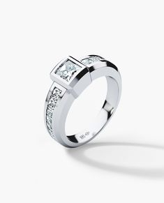 a white gold ring with princess cut diamonds