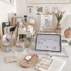 a desk with various items on it including a tablet