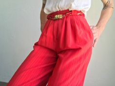 "Vintage knickerbockers high waist pants - Jean Claude Made in France 1970s Red pants with grey and gold stripes. Pleated at the waist. Knee length. Puffy legs with button on bottom. High waist with 2 buttons / zip closure . Braided belt in the same colores with gold buckle. 2 side pockets. In perfect condition. Size : FR36 US4 UK6 Our model wears usually a size S (UE36/38) and is 170cm/66,9\" tall. Measurements (flat): Waist: 30cm - 11,8\" Hips: 53cm - 20,8\" Front crotch: 35cm - 13,7\" Back cr Vintage Summer Pants With Belt Loops, Red High-waisted Pants With Belt Loops, Vintage Fitted Bottoms With Elastic Waistband, Retro High-waist Bottoms With Elastic Waistband, Retro Red Bottoms For Spring, Retro High Waist Bottoms With Elastic Waistband, Red Long Pants With Belt Loops, Vintage Pants With Elastic Waistband, Vintage Red Wide Leg Pants