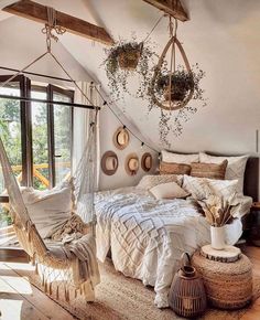 a bedroom with a hammock hanging from the ceiling and pillows on the bed