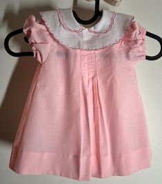 "Good condition absolutely no issues/smoke-free environment. True vintage labeled 12 months runs smaller - measures pit to pit 10\" / length (shoulder to bottom) 15\" w/a 2\" hem available / smoke-free environment (201)" Cute Pink Fitted Vintage Dress, Summer Vintage Dress With Ruffles For Dress-up, Cute Fitted Pink Vintage Dress, Sweet Short Sleeve Dress For Baptism, Vintage Summer Dresses For Baptism, Cute Pink Lined Dress, Lined Summer Dress For Baptism, Vintage Summer Dress For Dress-up Occasions, Sweet Short Sleeve Dress For First Birthday