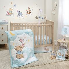 a baby's room with winnie the pooh crib bedding