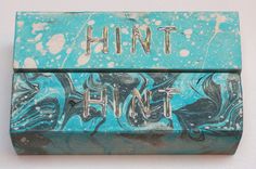 a blue box with the word hunt painted on it