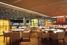 an empty restaurant with white tables and chairs