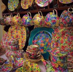 many colorful plates and bowls are on display