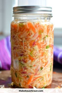 a mason jar filled with shredded carrots and coleslaw