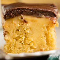 a piece of cake with chocolate frosting on it sitting on top of a white plate