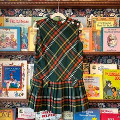 Description: Vintage 1970s Girls' Green and Red Plaid Pleated Drop Waist Dress Condition: Good Size: Size 7 Measurements:  Pit to Pit : 14" Total Length : 25" Plaid A Line Dress, 70s Catalog Fashion, Plaid Fall Dress, Retro Fitted School Dress, Retro Fitted Dress For School, Sleeveless Vintage Dress For Fall, Plaid Dress Outfit, Rosabella Beauty, Plaid Clothing