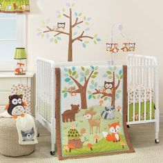 a baby crib bedding set with woodland animals and trees on it, including an owl