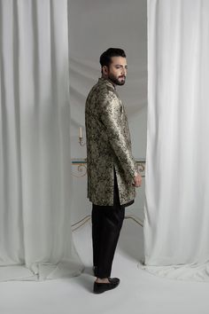 Upgrade your style with our Black and Gold Prince Coat. Made from luxurious brocade material, this front open coat exudes royalty. Paired with an Indian raw silk kurta pajama, it's the perfect ensemble for any formal event. Elevate your look and make a statement with this unique and elegant piece. 3-Piece Suit Designer Silk Fitted Outerwear, Fitted Silk Outerwear, Elegant Traditional Drape Outerwear For Party, Elegant Party Outerwear With Traditional Drape, Designer Straight Kurta Bandhgala For Ceremonial Occasions, Formal Festive Bandhgala With Resham Embroidery, Designer Ceremonial Bandhgala With Straight Kurta, Transitional Silk Nehru Jacket For Designer Wear, Designer Nehru Jacket With Zari Work For Festive