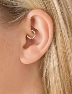 a woman's ear with two small stars on it