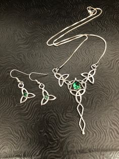 I will fabricate this unique and gorgeous set for you, in sterling silver, and using lab-created Emeralds. This is a lovely Celtic inspired wedding set which will enhance your wedding theme! I fabricated the necklace using 5 sterling silver Trinity knots with a center 8mm round Emerald. I've then solder attached a 16 inch sterling silver box chain to either jumping on opposing ends. The total length of the necklace is 18 inches long, but if you want it shorter, please let me know and I can adjus Elegant Sterling Silver Jewelry In Silver, Elegant Silver Sterling Silver Jewelry, Traditional Sterling Silver Jewelry Sets With Elegant Design, Anniversary Sterling Silver Jewelry Sets With Elegant Design, Sterling Silver Jewelry Sets With Intricate Design, Sterling Silver Jewelry Sets With Intricate Design For Gift, Hand Set Sterling Silver Pendant Jewelry, Traditional Sterling Silver Jewelry Set With Matching Earrings, Fine Jewelry Hand Set Sterling Silver Sets