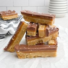 several pieces of chocolate and peanut butter bars stacked on top of each other