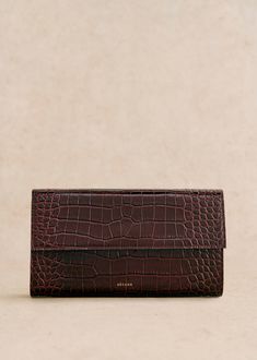 Hand-held;Made in our Italian atelier;Smooth crocodile-embossed leather exterior;Leather lining;Snap closure;Zipped pocket inside;Dimensions: 24.5 x 4 x 13.5 cm / 9.4 x 1.5 x 5.1 in Brown Leather Clutch, Denim Suit, Suit Shoes, Small Leather Goods, Parisian Style, Leather Clutch, Embossed Leather, Cowhide Leather, Inside Pocket