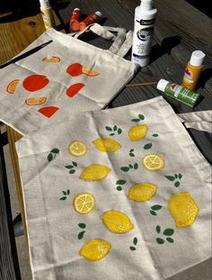 two bags with lemons and oranges painted on them