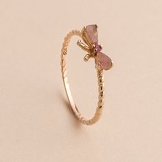 Add a little character with this bow style ring to your outfit. Handcrafted in gold plated sterling silver, this ring features genuine pink tourmaline stones and a deep red ruby gemstone. Approximate stone measurement: 3/8" x 1/4" Material: sterling silver, genuine pink tourmaline gemstone, genuine ruby gemstone Item #: 13159 FAIRPRICING $85 TOORIGINAL | $110 ESTIMATED RETAIL All of our items are priced specially while keeping the same high standard quality. Cute Aesthetic Rings, Korean Jwellery, Stylish Jewelry Accessories, Rings Pink, Aesthetic Rings, Pink Garnet, Fancy Jewelry Necklace, Bow Style, Pink Tourmaline Ring