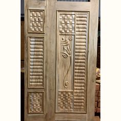 two wooden doors with carved designs on them