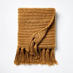 a brown blanket with fringes on it