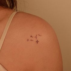 the back of a woman's shoulder with small stars on it