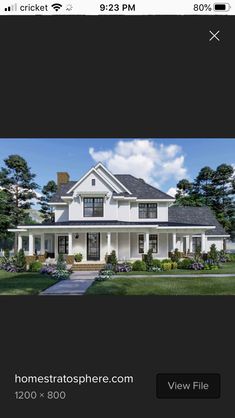 a white house with black shutters on the front and side windows, surrounded by green grass