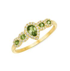 a yellow gold ring with green and white stones