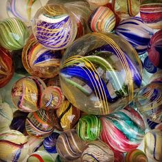 there are many different colored glass balls together