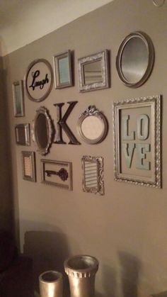 a wall with many different frames on it