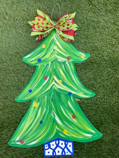 a green christmas tree shaped ornament on the grass