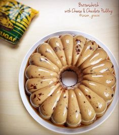 a bundt cake sitting on top of a white plate next to a bag of chips