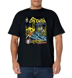 a man wearing a batman t - shirt with an image of the bat on it