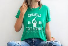 Griswold Tree Service Bella Canvas Shirt Perfect for any Christmas Vacation fan!  Looks great! Little full! Lotta sap!  This classic unisex jersey short sleeve tee fits like a well-loved favorite. Soft cotton and quality print make users fall in love with it over and over again. These t-shirts have-ribbed knit collars to bolster shaping. The shoulders have taping for better fit over time. Dual side seams hold the garment's shape for longer. .: 100% Airlume combed and ringspun cotton (fiber conte Christmas With The Kranks Movie, Christmas With The Kranks, Griswold Family, Cousin Eddie, Funny Matching, National Lampoons Christmas Vacation, National Lampoons, Movie Tees, Tree Service