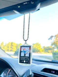 an mp3 player hanging from the dashboard of a car