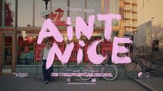 a man standing in front of a store window with the words'anti nice'painted on it