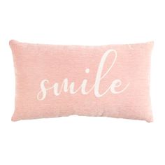 a pink pillow with the word smile on it's front and bottom, in white lettering