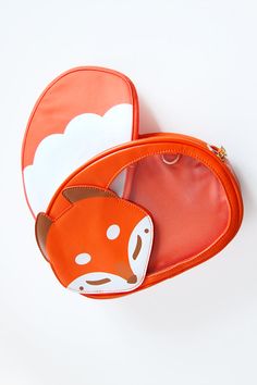 A cute sleepy friend to carry all your pins! Sleeping fox bag is a faux leather bag that has a window over her tail for showing off pins. Comes with one tail insert! External dimensions are approximately 10 x 7 x 2 inches. This bag has comes with two sets of straps: one set for backpack mode and another singular longer strap for wearing over the shoulder. The inside of the bag has coordinating brown lining. It also has a back pocket with zipper for easy storage, as well as gold flower zipper pul Orange Soft Leather Bag, Fox Umbrella, Fox Tail On Bag, Fox Backpack, Pokemon Ita Bag, Fox Purse, Fox Bag, Faux Leather Bag, Mobile Device