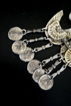 "Boho vintage 70s, silver tone metal necklace. One strand , chunky long chain. Accented with a hand made, hammered, large, geometric , brass pendant and dangle, antique coins tassel. Different. Look like the anchor , but it's not. Could be some symbol. Exotic,statement, stylish, rare. Excellent condition. Clean. No any damage, no discoloration, no missing parts. You can use as a gift. Length of the chain:28,0\" Size of the pendant with a tassel:4,5\"x2,75\" Length of the tassel :1,5\" Size of th Metal Necklace With Coin Pendant, Silver Metal Coin Necklace, Nickel Free Metal Coin Pendant Necklace, Silver Dangle Long Necklace, Silver Metal Coin Pendant Necklace, Silver Metal Medallion Necklace, Silver Metal Pendant Coin Necklace, Silver Coin Pendant Necklace, Bohemian Metal Medallion Necklace With Coin Pendant