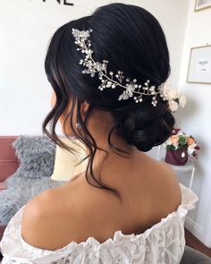 the back of a woman's head wearing a bridal hair piece