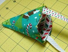 a close up of a piece of fabric on a cutting board with scissors and tape