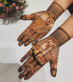 two hands with henna designs on them