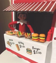 Elf On The Shelf Ideas Funny Hilarious Bad, Elf 2024, Christmas Card Photo Ideas, Burger Stand, Funny Elf On The Shelf, Elf Ideas Easy, Elf Kit, Awesome Elf On The Shelf Ideas, Funny Christmas Card