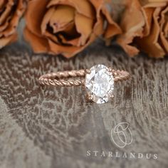 a close up of a ring with flowers in the background