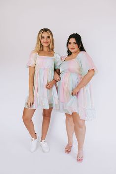 For the days you need more color, we've got you covered. Introducing the Head In The Clouds Dress to our Exclusive collection! A one-of-a-kind dress that is as fun, shimmery, + vibrant as you! Details Iridescent pastels Shimmery look Rainbow colored Lined Short puff sleeves Square neckline Elastic along shoulders Smocked back Tier hem Soft! Mini-length dress Sizing Approximate measurements: SIZE LENGTH BUST* WAIST* XS 33" 28" 24" Small 35" 30" 26" Medium 36" 32" 28" Large 36" 34" 30" XL 36.5" 36 Fun Mini Dress For Spring, Fun Mini Length Spring Dresses, Playful Mini Length Party Dresses, Playful Mini Dress For Spring Party, Spring Fitted Iridescent Mini Dress, Playful Spring Mini Dress For Parties, Spring Iridescent Fitted Mini Dress, Fun Mini Dress For Spring Party, Fitted Iridescent Mini Dress For Spring