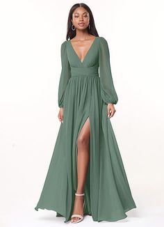 a woman wearing a long green dress with a slited skirt and high slits