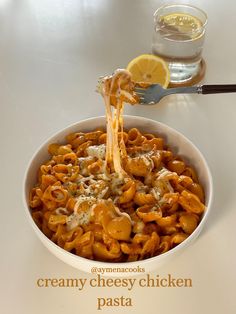 a white bowl filled with pasta covered in cheese