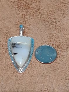 One of a kind, handcrafted, Scenic Peruvian Opal pendant. Measures about 44mm X 21mm. CHAIN NOT INCLUDED. Handmade Sterling Silver Arrowhead Necklace, Handmade White Amulet Jewelry, Unique Handmade Arrowhead Necklaces, Artisan Untreated Jewelry For Collectors, Untreated Round Pendant Jewelry Gift, Unique White Collectible Jewelry, Unique One Of A Kind White Jewelry, Unique One-of-a-kind White Jewelry, Bohemian Arrowhead Jewelry As Gift