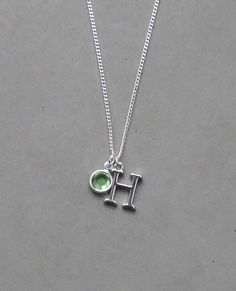 The initial is silver plated and measures 10 mm x 15 mm. It is strung on a silver plated tiny 1.3 mm curb chain with a lobster clasp closure. Choose the length from the drop down. To add a birthstone charm to this necklace, follow link below to purchase birthstone charm. https://www.etsy.com/listing/634099372/add-a-birthstone-charm?ga_search_query=add&ref=shop_items_search_1 Personalized Silver Teardrop Jewelry, Adjustable Silver Charm Necklace With Initials, Silver Charm Necklaces With Adjustable Chain For Birthday, Green Sterling Silver Charm Necklace With Lobster Clasp, Silver Hypoallergenic Charm Necklace For Birthday, Silver Teardrop Birthstone Charm Necklace, Silver Charm Necklaces With Birthstone And Dangle Shape, Silver Charm Necklaces With Birthstone Dangle, Green Sterling Silver Charm Necklace