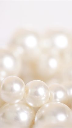 many white pearls are scattered together on the table