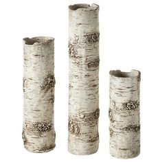 three tall white vases sitting next to each other