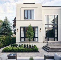 an outdoor living area with couches and tables